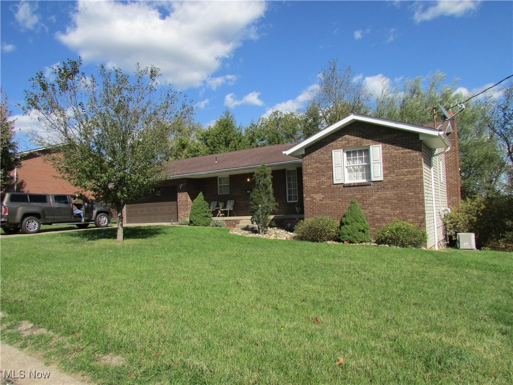 ranch-style house with a front yard and a garage