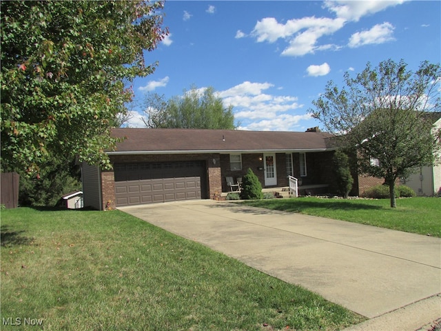 ranch-style home with a garage and a front lawn