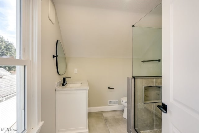 bathroom featuring toilet, lofted ceiling, walk in shower, and vanity