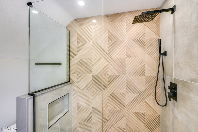 details featuring a shower and a textured ceiling