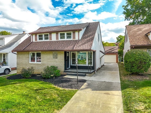 view of front of property with an outdoor structure, a front lawn, and a garage