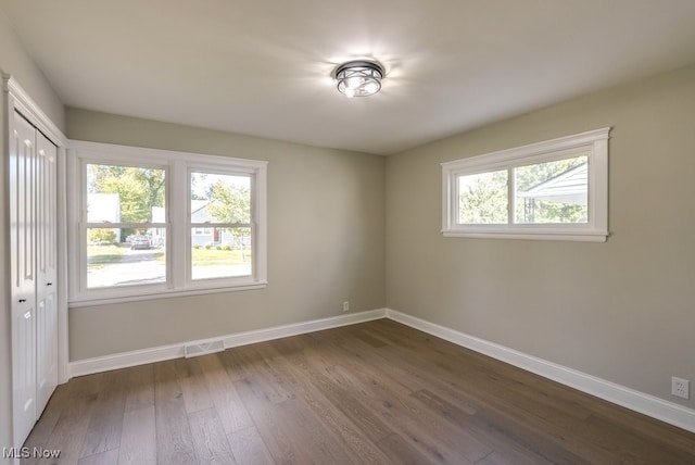 spare room featuring dark wood-type flooring