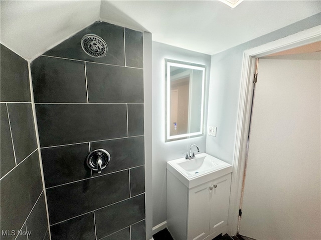 bathroom with vanity and tiled shower