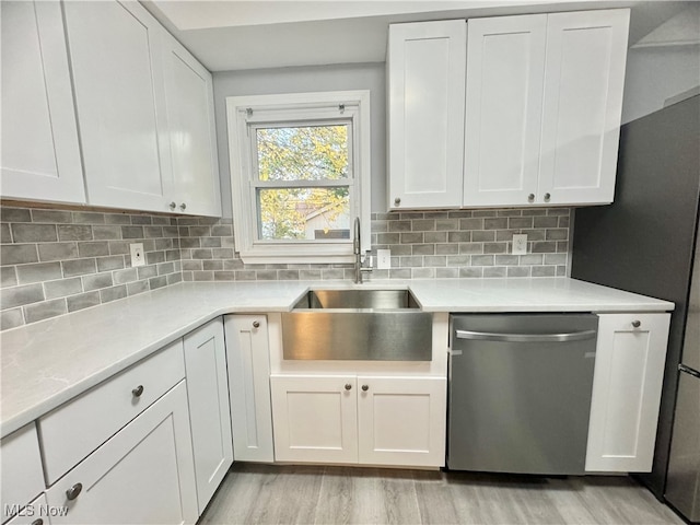 kitchen with white cabinets, stainless steel dishwasher, and light wood-type flooring