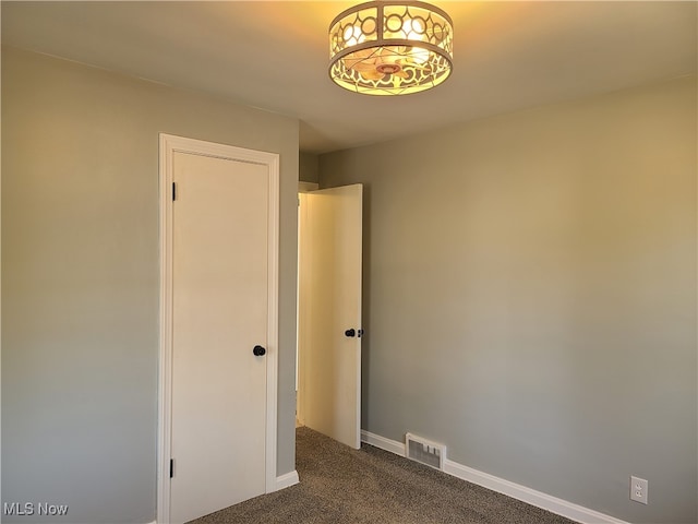 empty room with dark carpet