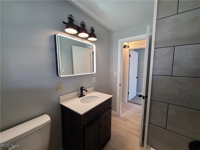 bathroom featuring vanity, hardwood / wood-style floors, and toilet