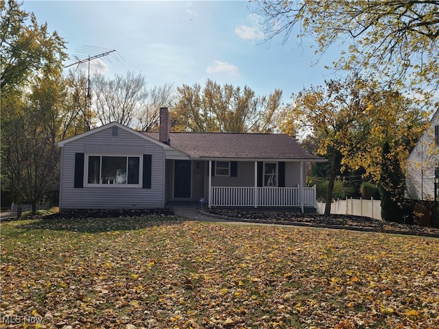 single story home with a front yard and covered porch