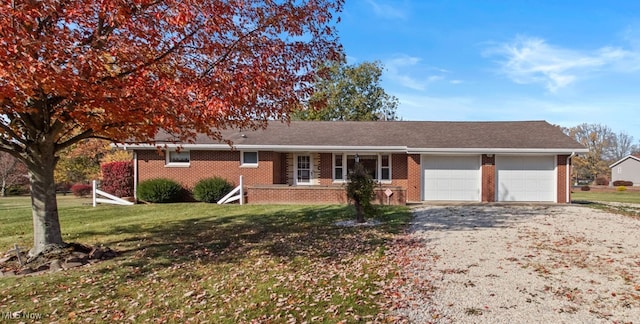 single story home featuring a front lawn and a garage