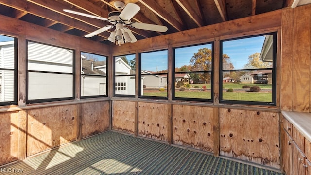 unfurnished sunroom with ceiling fan