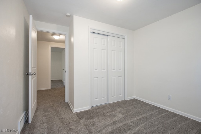 unfurnished bedroom with a closet and carpet floors