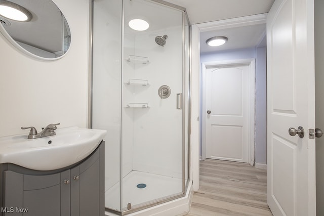 bathroom with vanity, hardwood / wood-style flooring, and an enclosed shower