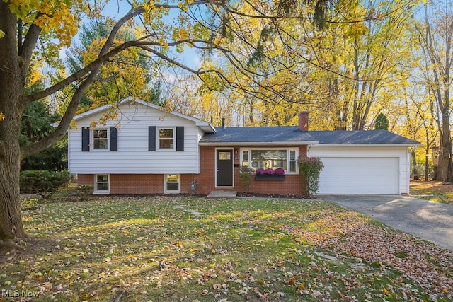 tri-level home featuring a garage and a front lawn