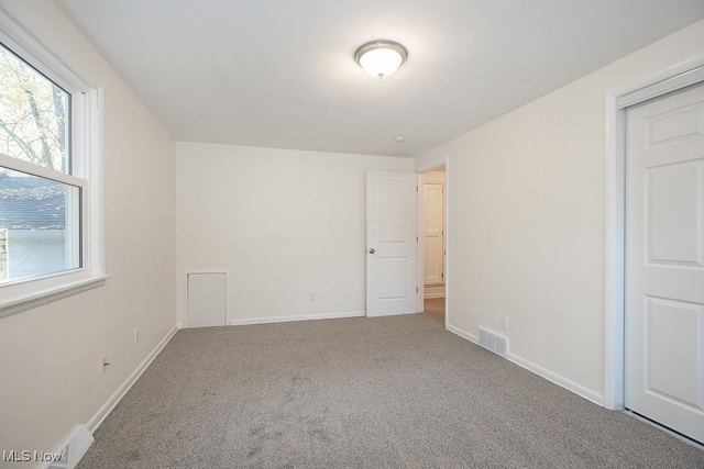 spare room featuring carpet floors