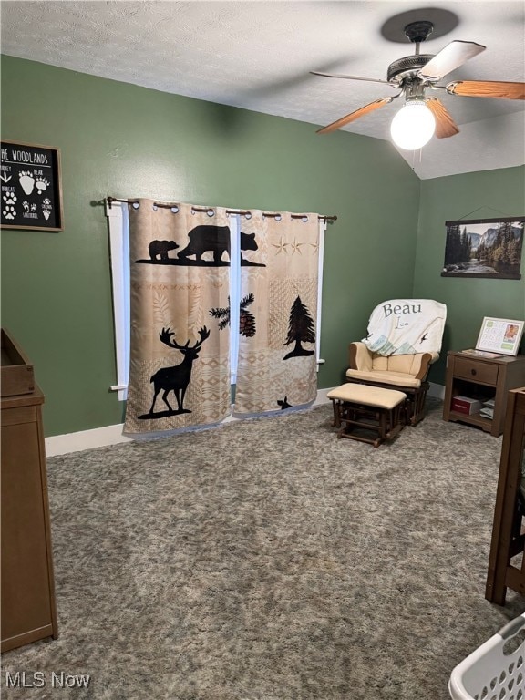 bedroom featuring ceiling fan, carpet, and a textured ceiling