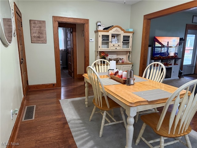 dining area with dark wood-type flooring