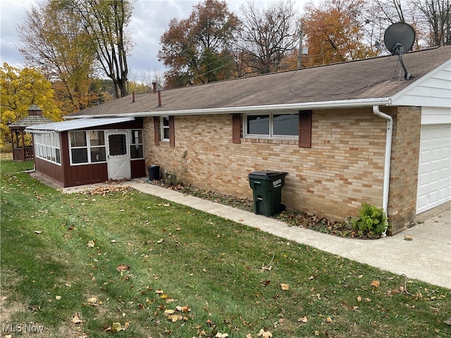 exterior space featuring a lawn and a garage