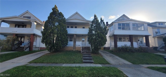 view of front of house with a porch and a front lawn