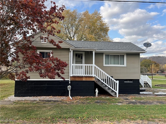 view of front of property with stairs and roof with shingles