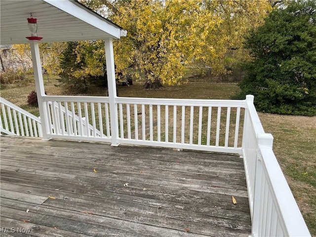 wooden deck featuring a yard