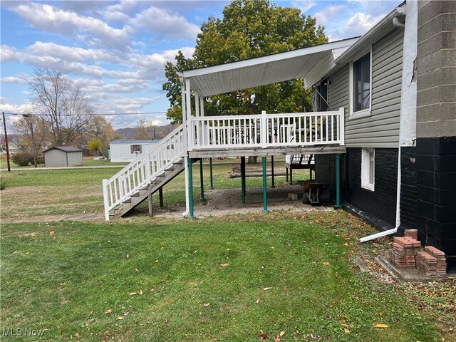 view of yard with a shed and a wooden deck