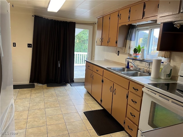 kitchen with white electric range oven, sink, light tile patterned floors, and tasteful backsplash