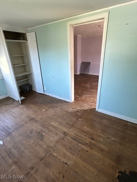 unfurnished bedroom with dark hardwood / wood-style floors