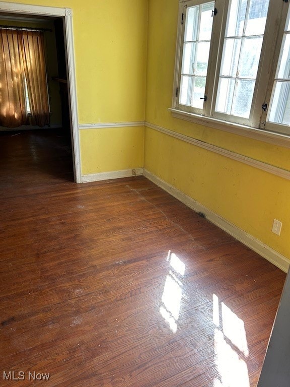 spare room featuring dark hardwood / wood-style flooring