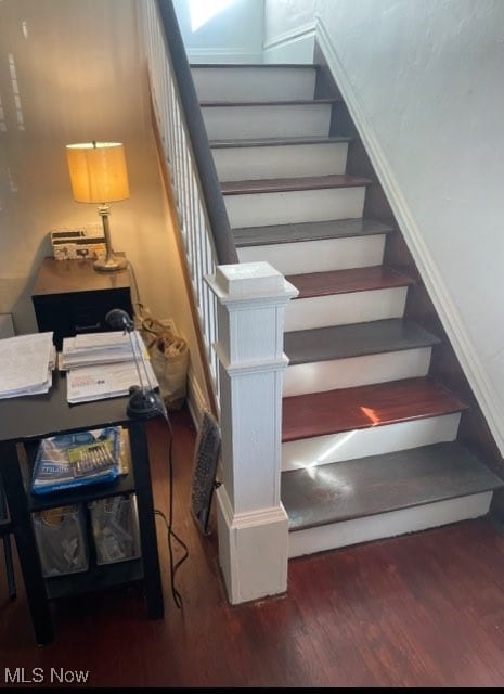 stairway featuring hardwood / wood-style flooring