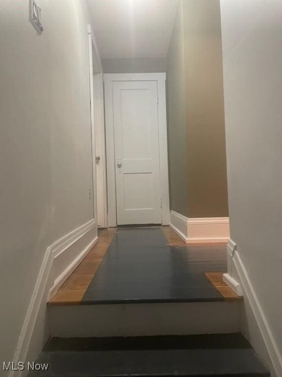 hallway with dark hardwood / wood-style flooring