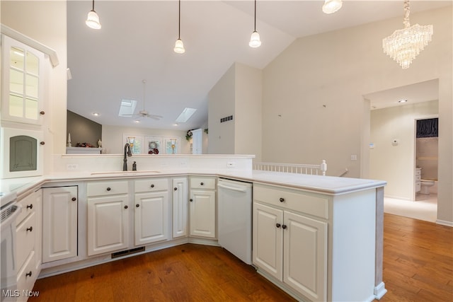 kitchen with sink, a skylight, white dishwasher, hardwood / wood-style floors, and white cabinets