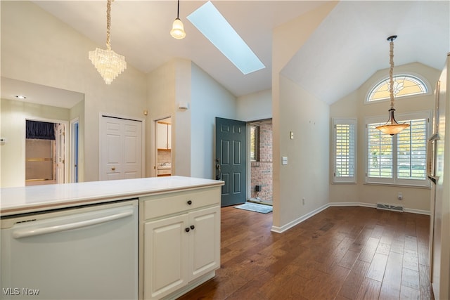 kitchen featuring dishwasher, dark wood-type flooring, an inviting chandelier, high vaulted ceiling, and a skylight