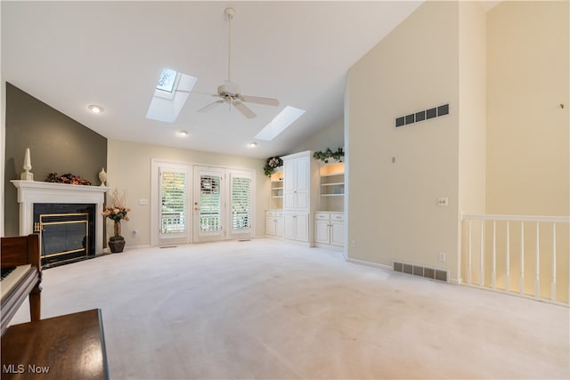 living room featuring high vaulted ceiling, a fireplace, light colored carpet, and ceiling fan