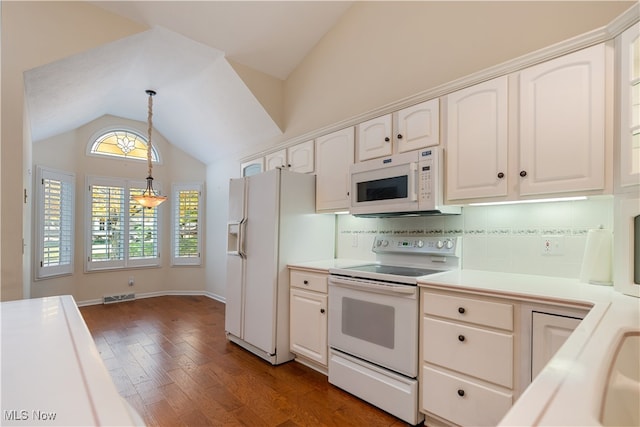 kitchen featuring white appliances, white cabinetry, and plenty of natural light