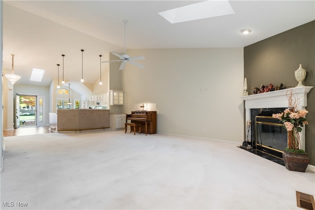 living room featuring light carpet, high vaulted ceiling, a fireplace, and ceiling fan