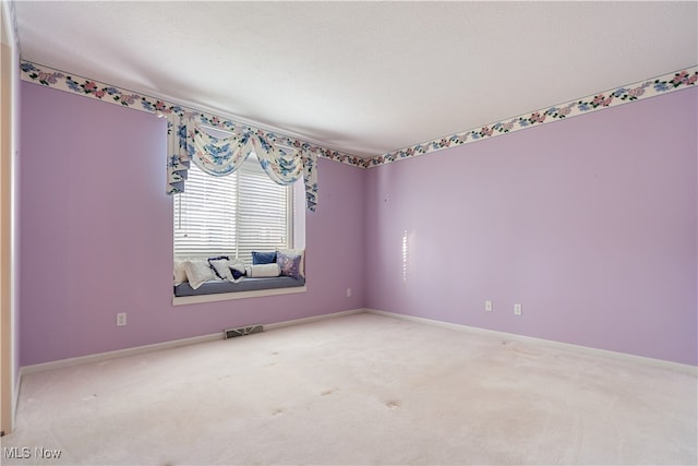 carpeted spare room with a textured ceiling