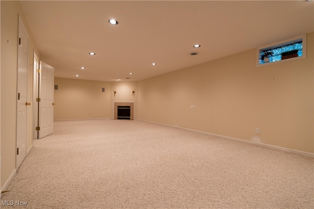 basement featuring light colored carpet