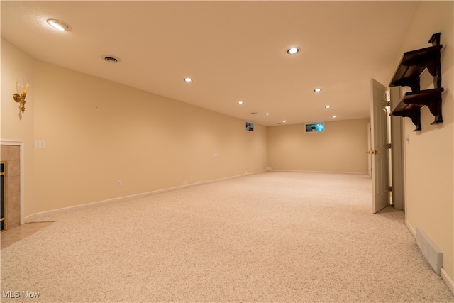 interior space with a tile fireplace