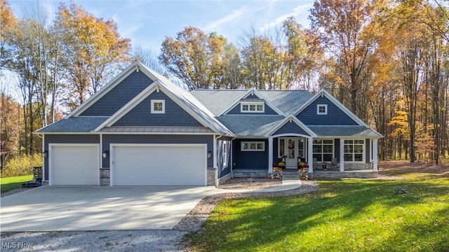 view of front facade with covered porch, a garage, and a front lawn