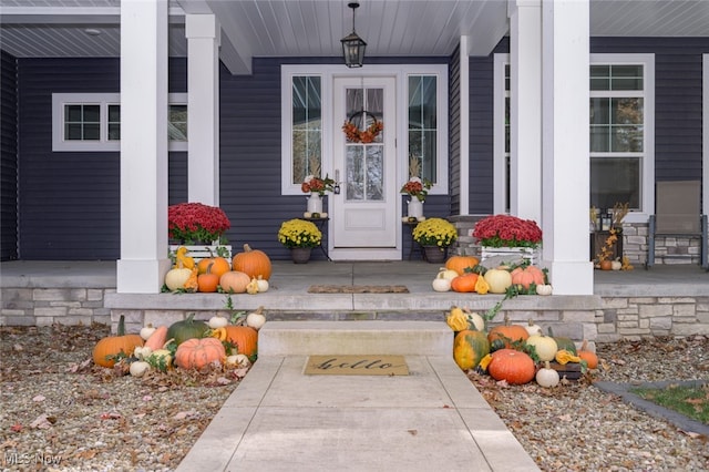 view of exterior entry with a porch