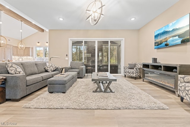 living room featuring vaulted ceiling with beams, light hardwood / wood-style floors, and a chandelier