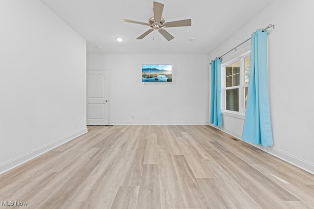 spare room with light hardwood / wood-style flooring and ceiling fan