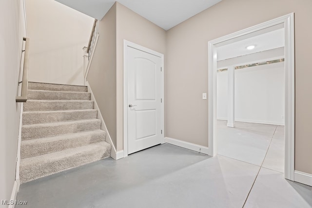 stairway featuring concrete floors