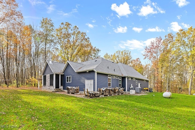 view of home's exterior with a yard and central AC unit