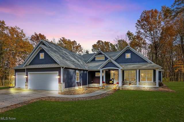 craftsman house with a lawn and a garage