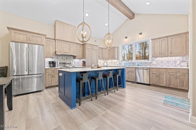 kitchen featuring decorative backsplash, light wood-type flooring, stainless steel appliances, beam ceiling, and hanging light fixtures