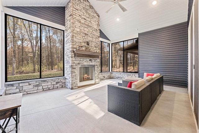 view of patio / terrace with an outdoor stone fireplace and ceiling fan