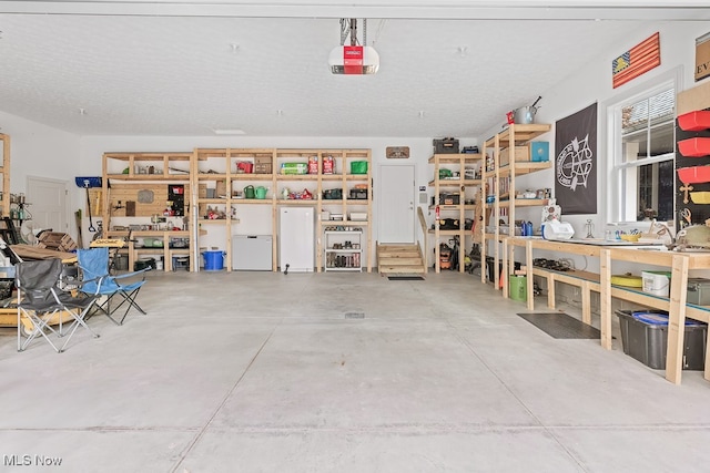 garage with a workshop area and a garage door opener