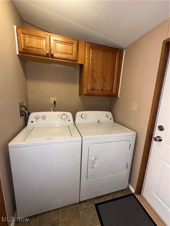 washroom with cabinets, washer and dryer, and tile patterned flooring