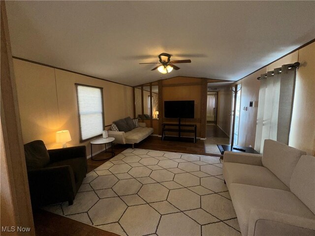 living room with light hardwood / wood-style flooring, lofted ceiling, and ceiling fan