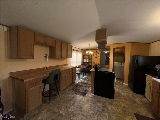 kitchen with a notable chandelier, decorative light fixtures, washer and clothes dryer, a center island, and butcher block countertops